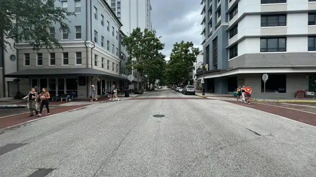 Buildings, sidewalk seating, and pedestrians along Central Boulevard in downtown Orlando.